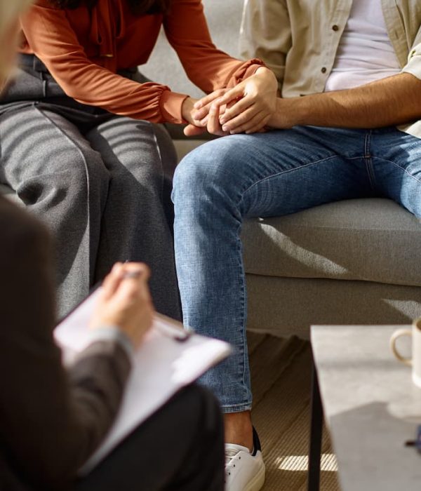 married-couple-holding-hands-during-family-therapy-2022-02-18-04-36-50-utc (1)